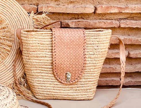 Moroccan Tribe presents the soft leather and rattan handmade bag a captivating piece of art for your home.