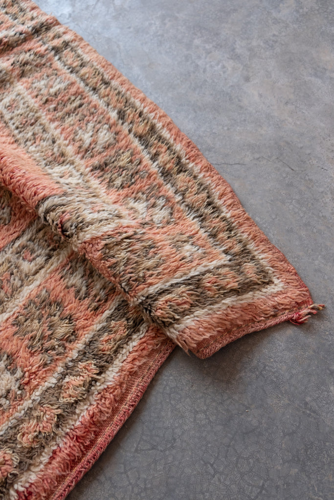 Vintage Moroccan rug  with Berber tribal patterns and neutral hues.