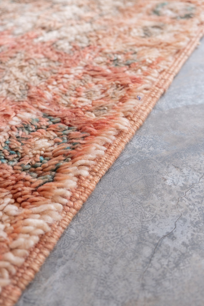 Vintage Moroccan rug featuring traditional tribal motifs and neutral colors.