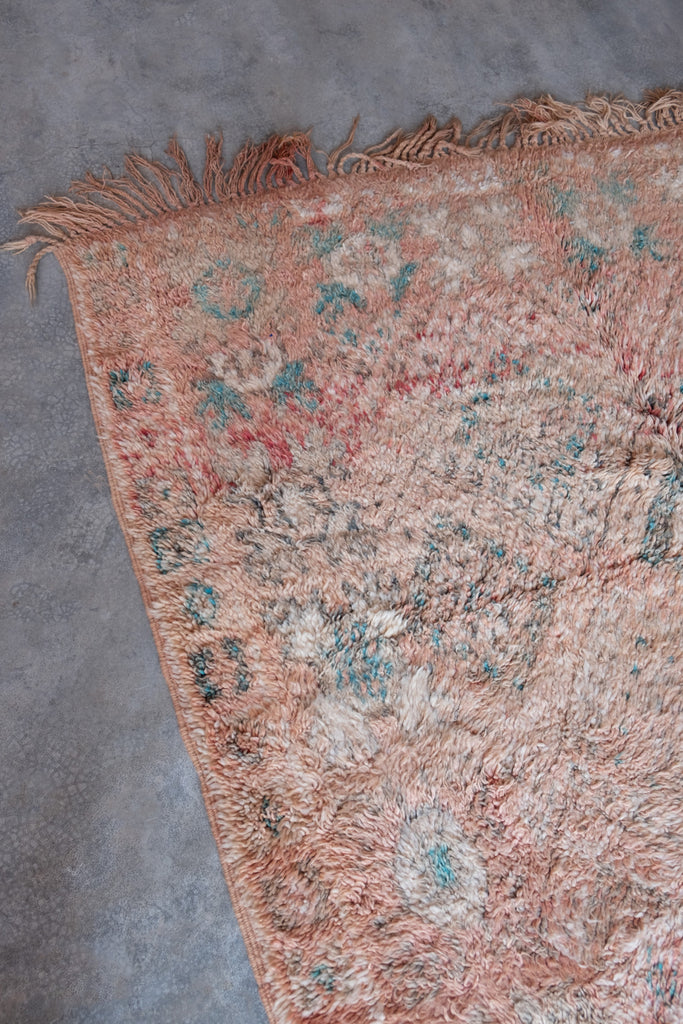 Vintage Moroccan rug  displaying traditional tribal motifs.