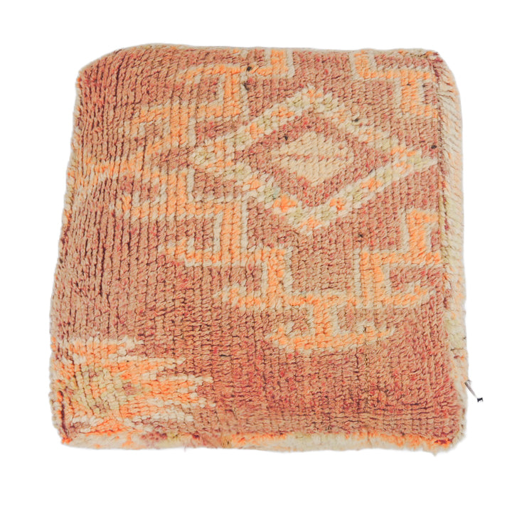 Vintage Moroccan cushion in tangerine with intricate details.