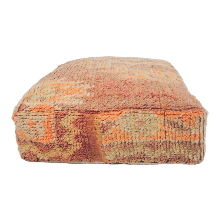 Vintage Moroccan floor cushion in tangerine with intricate details a cozy addition to Moroccan-inspired interiors.
